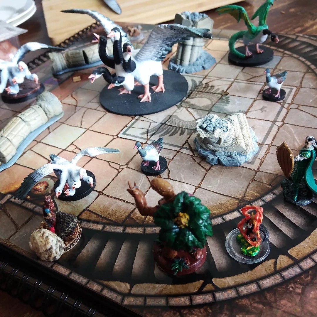 A round dungeon background with minifigures of various beasts